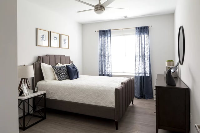 Bed dresser framed art ceiling fan bedroom at Frontgate in Louisville Student Accommodation