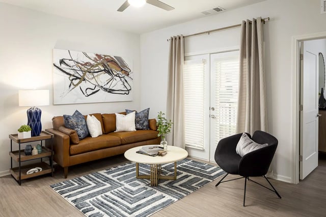Brown sofa abstract art side table contemporary living room at Frontgate in Louisville Student Accommodation