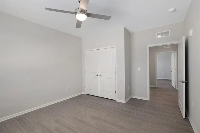 Closet doors ceiling fan and hallway Bedroom at The Belltower in Louisville Student Accommodation