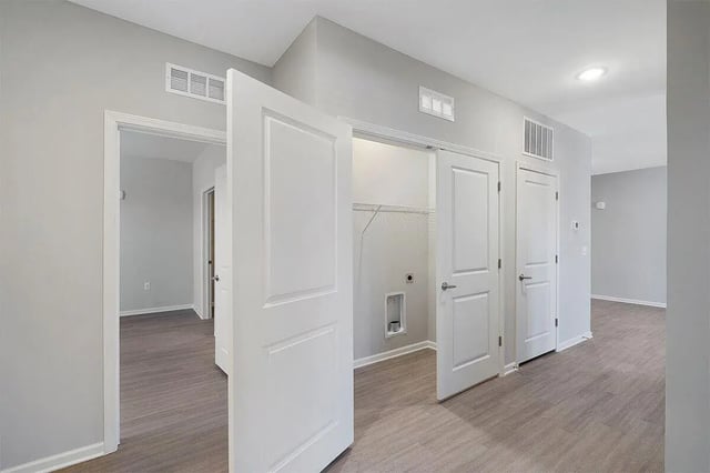 Interior doors and laundry hookups hallway view at The Belltower in Louisville Student Accommodation