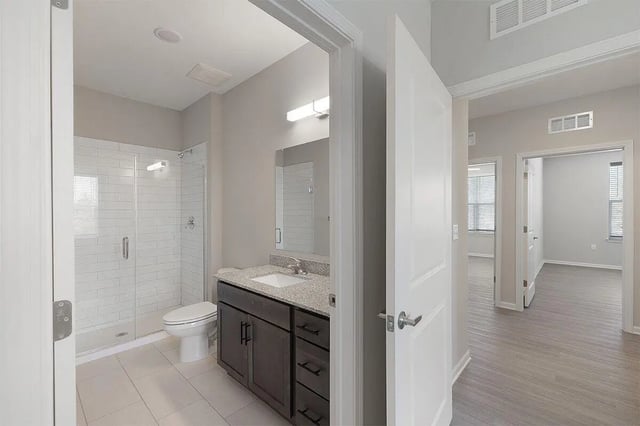 Shower toilet vanity with granite countertop bathroom at The Belltower in Louisville Student Accommodation