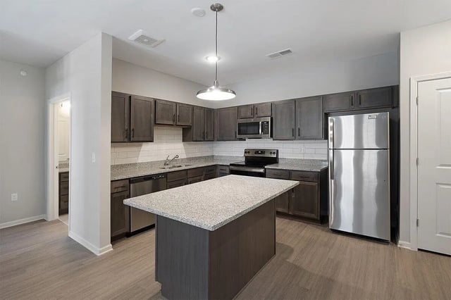Modern kitchen with island stainless steel appliances kitchen at The Belltower in Louisville Student Accommodation