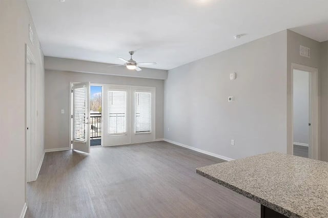 Ceiling fan balcony doors and granite counter living room at The Belltower in Louisville Student Accommodation