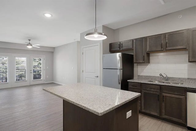 Island kitchen area with stainless steel refrigerator kitchen at The Belltower in Louisville Student Accommodation