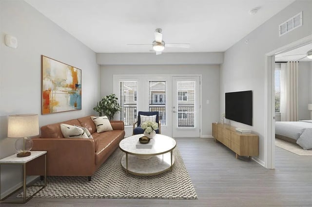 Brown leather couch coffee table abstract painting living room at The Belltower in Louisville Student Accommodation