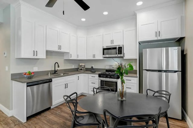 Modern kitchen with stainless steel appliances and dining table kitchen at Flats on Elk in Glendale Student Accommodation