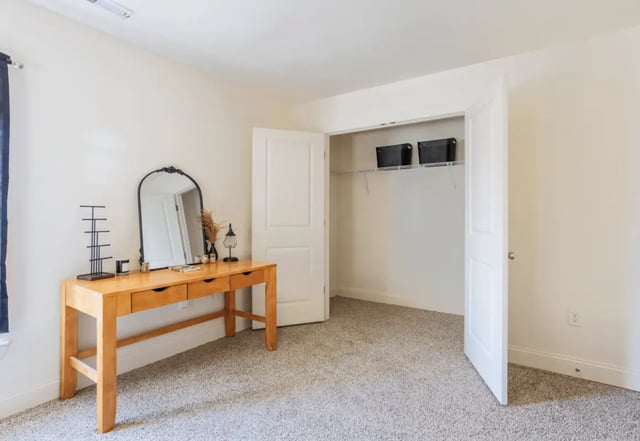 Desk mirror closet with baskets Bedroom at Copper Beech at Ames in Ames Student Accommodation