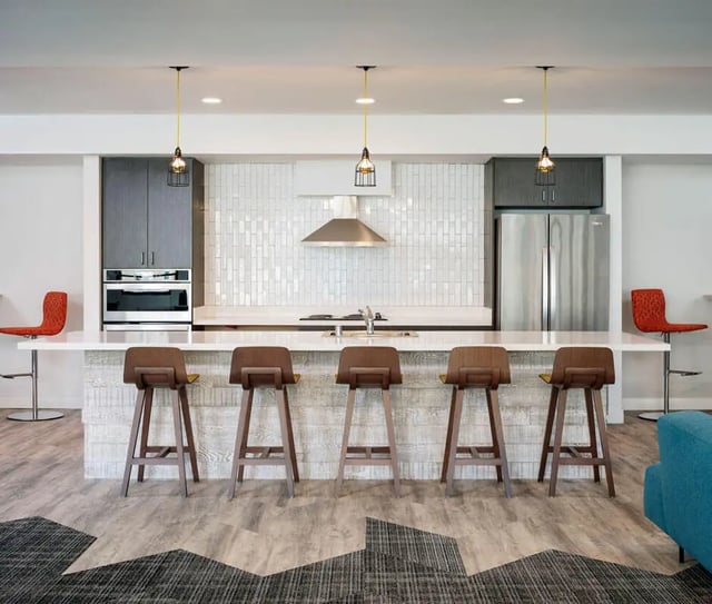 Modern kitchen with island bar seating kitchen at M @ College in San Diego Student Accommodation