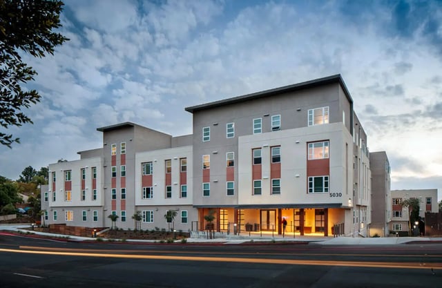 Modern apartment building with many windows exterior. at M @ College in San Diego Student Accommodation