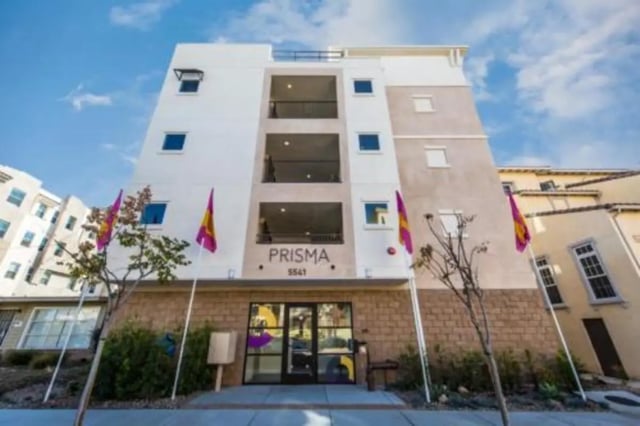 Prisma building with flags and entrance exterior at Prisma in San Diego Student Accommodation