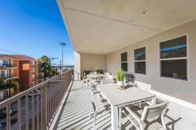 Tables chairs and plants on patio exterior at Prisma in San Diego Student Accommodation