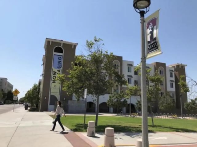 Now leasing banner on building exterior at Prisma in San Diego Student Accommodation