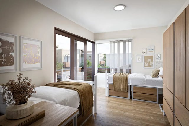 Two beds with wooden dressers and artwork Bedroom at The Cove in Goleta Student Accommodation