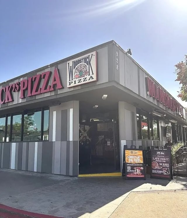 Pizza restaurant exterior with signs and windows at The Cove in Goleta Student Accommodation