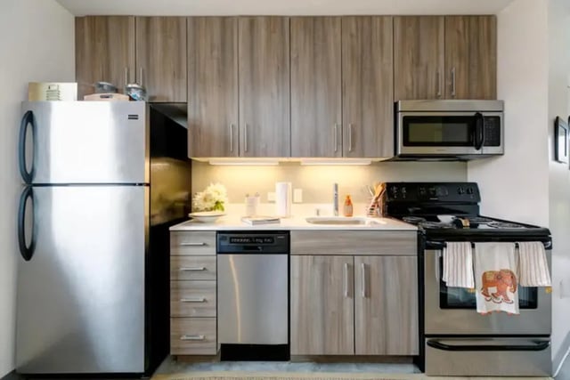 Stainless steel refrigerator dishwasher oven microwave kitchen at The Loop in Isla Vista Student Accommodation