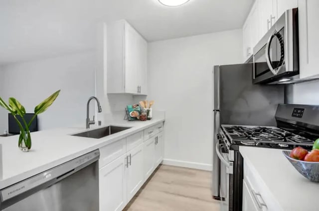 Modern kitchen with stainless steel appliances and white cabinets kitchen at Valleywood in Los Angeles Student Accommodation