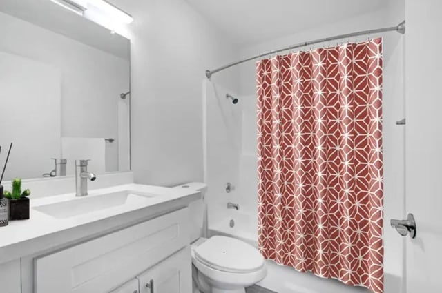White sink toilet and red patterned shower curtain bathroom at Valleywood in Los Angeles Student Accommodation