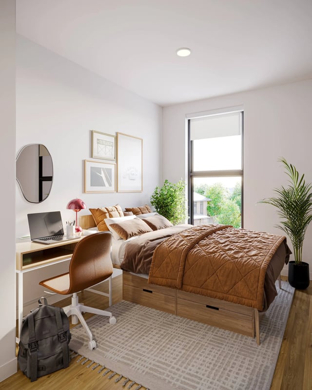 Bed desk chair laptop and plant bedroom at Ever West Lafayette in West Lafayette Student Accommodation