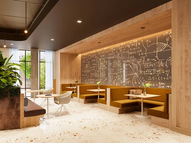 Booth seating with tables and a chalkboard wall at Ever West Lafayette in West Lafayette Student Accommodation