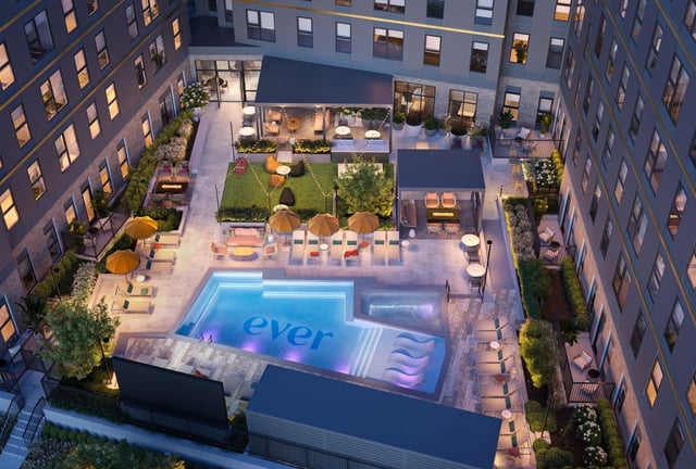 Pool lounge chairs umbrellas and hot tub exterior at Ever West Lafayette in West Lafayette Student Accommodation