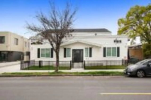 White building entrance with fence exterior at Heritage 2831 in Los Angeles Student Accommodation