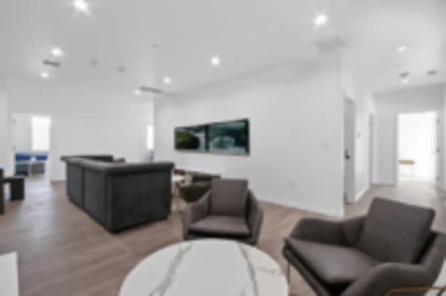 Gray sectional sofa with chairs and coffee table living room at Heritage 2831 in Los Angeles Student Accommodation