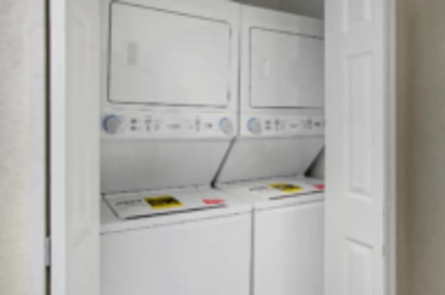 Stacked white washer dryer laundry area at Heritage 2831 in Los Angeles Student Accommodation