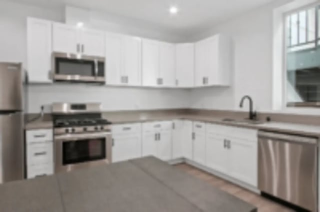 Modern kitchen with white cabinets stainless steel appliances kitchen at Heritage 2831 in Los Angeles Student Accommodation