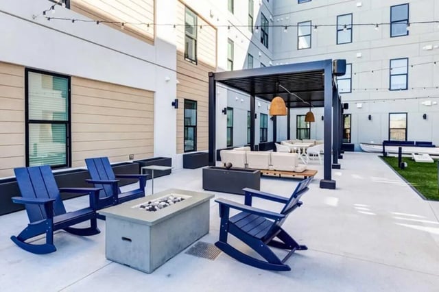 Blue chairs fire pit patio furniture exterior at The Helmsman in Savannah Student Accommodation