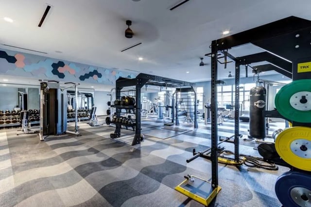 Weight racks punching bag and exercise machines Gym at The Helmsman in Savannah Student Accommodation