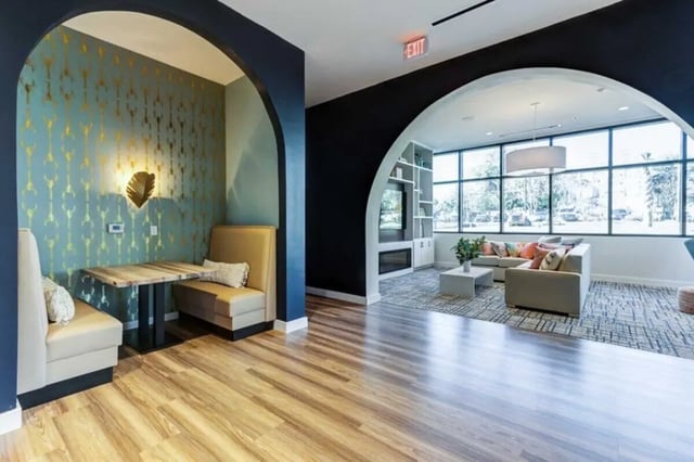 Booth seating and lounge with large windows living room at The Helmsman in Savannah Student Accommodation