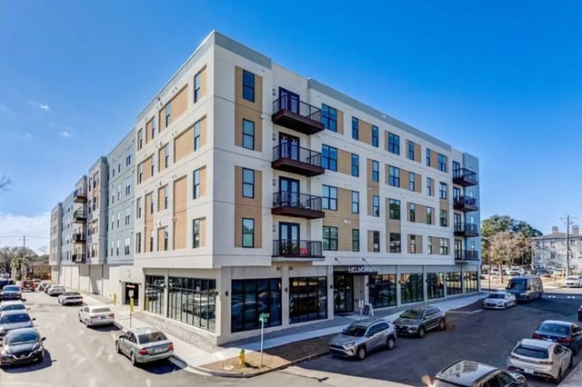Modern apartment building with balconies and cars exterior at The Helmsman in Savannah Student Accommodation