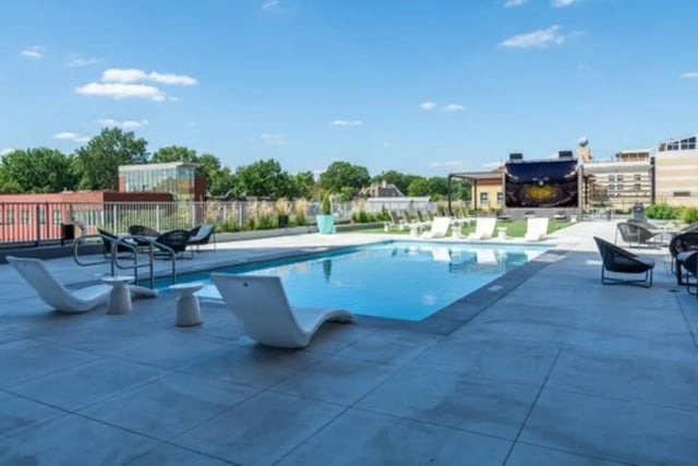 Pool lounge chairs and large screen patio area at Everly On The Loop in St. Louis Student Accommodation