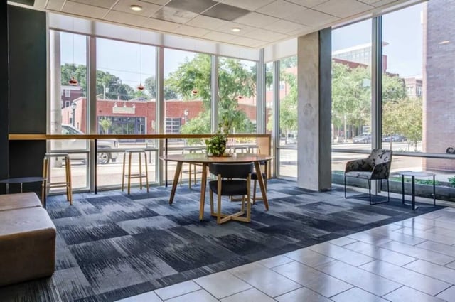 Round table chairs stools sofa common area at Everly On The Loop in St. Louis Student Accommodation