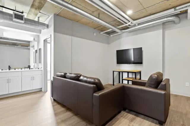 Leather sofas and television in living area at Auraria Student Lofts in Denver Student Accommodation