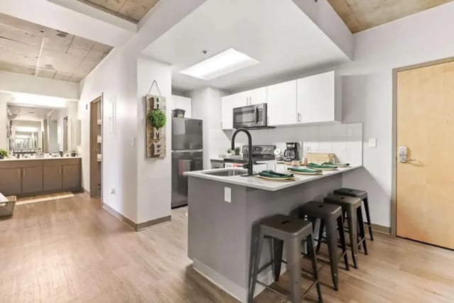 Kitchen island with stools and cabinets kitchen at Auraria Student Lofts in Denver Student Accommodation
