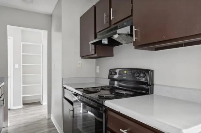 Black stove and cabinets kitchen at Aviator Apartments in Colorado Springs Student Accommodation