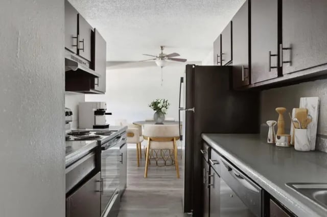 Kitchen with appliances dining table and chairs Kitchen at Aviator Apartments in Colorado Springs Student Accommodation
