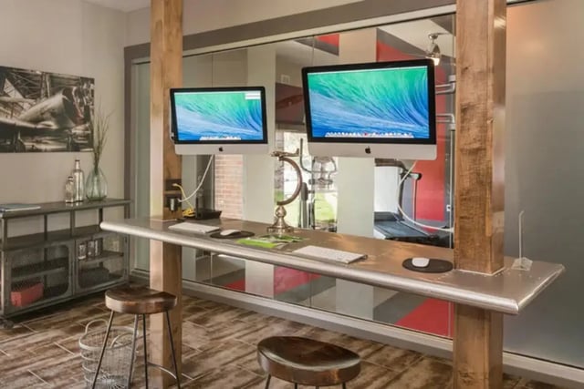Two computers on metal desk with stools Study Area at Aviator Apartments in Colorado Springs Student Accommodation