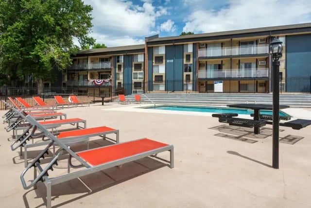 Orange lounge chairs and picnic tables exterior at Aviator Apartments in Colorado Springs Student Accommodation