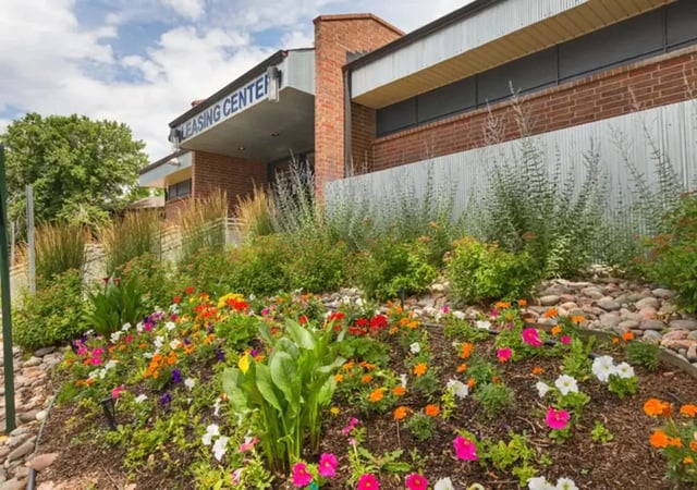 Leasing center entrance with colorful flower garden Exterior at Aviator Apartments in Colorado Springs Student Accommodation