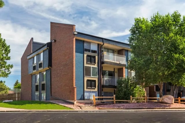 Brick building with blue accents balconies exterior at Aviator Apartments in Colorado Springs Student Accommodation