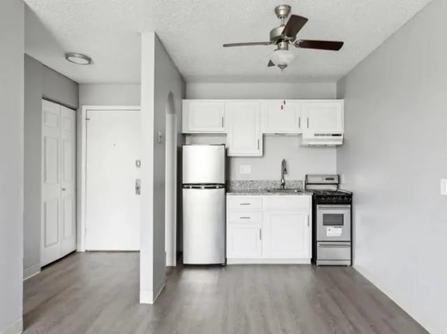 Fridge cabinets sink stove kitchen at Chestnut Springs Apartments in Colorado Springs Student Accommodation