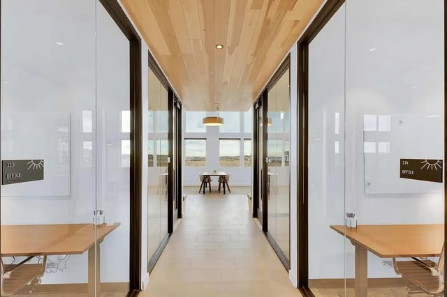 Hallway with desks and chairs shared workspace at Claro at High Point in Aurora Student Accommodation