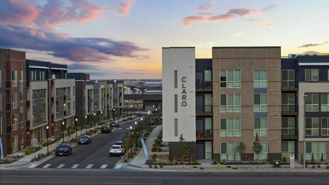 Modern apartment buildings with cars and streetlights exterior at Claro at High Point in Aurora Student Accommodation