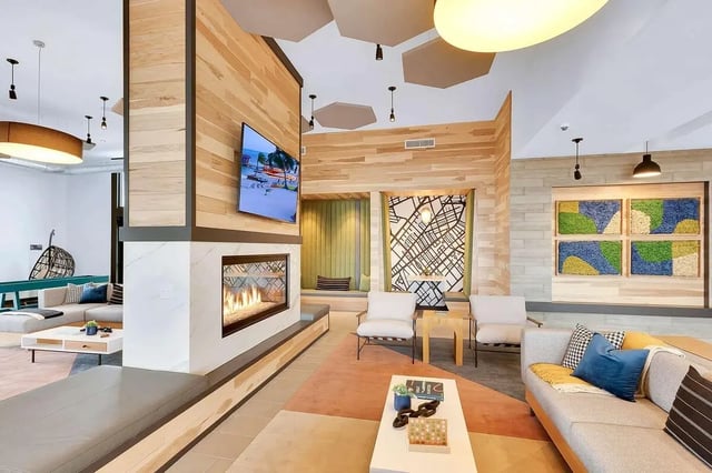 Modern living room with fireplace and lounge area Living room at Claro at High Point in Aurora Student Accommodation