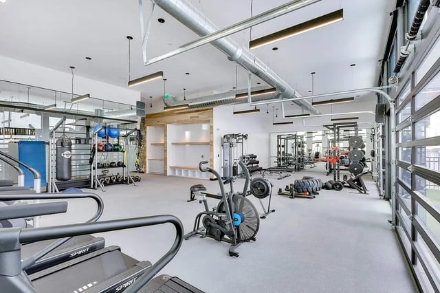 Treadmills punching bag weights gym equipment fitness area at Claro at High Point in Aurora Student Accommodation