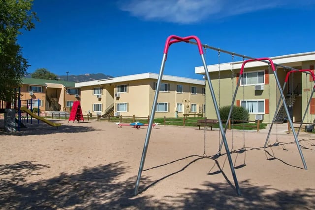 Swings slide and seesaw in playground exterior at Copper Chase Apartments in Colorado Springs Student Accommodation