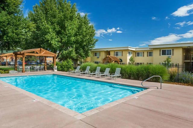 Pool with lounge chairs and covered seating exterior at Copper Chase Apartments in Colorado Springs Student Accommodation