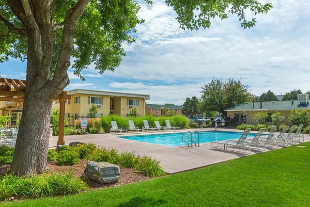 Swimming pool with lounge chairs exterior at Copper Chase Apartments in Colorado Springs Student Accommodation